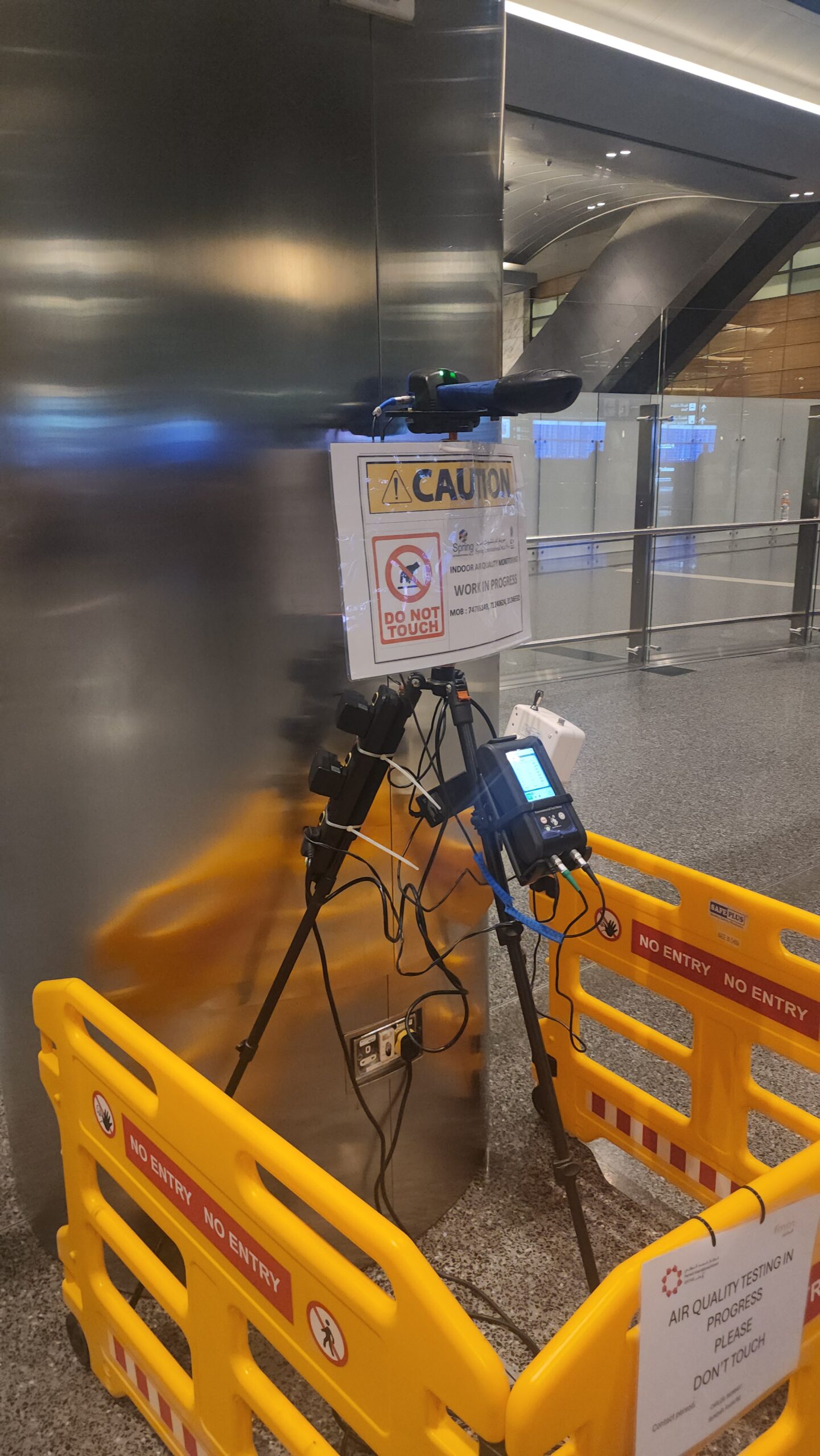 Air quality monitoring station with caution signage